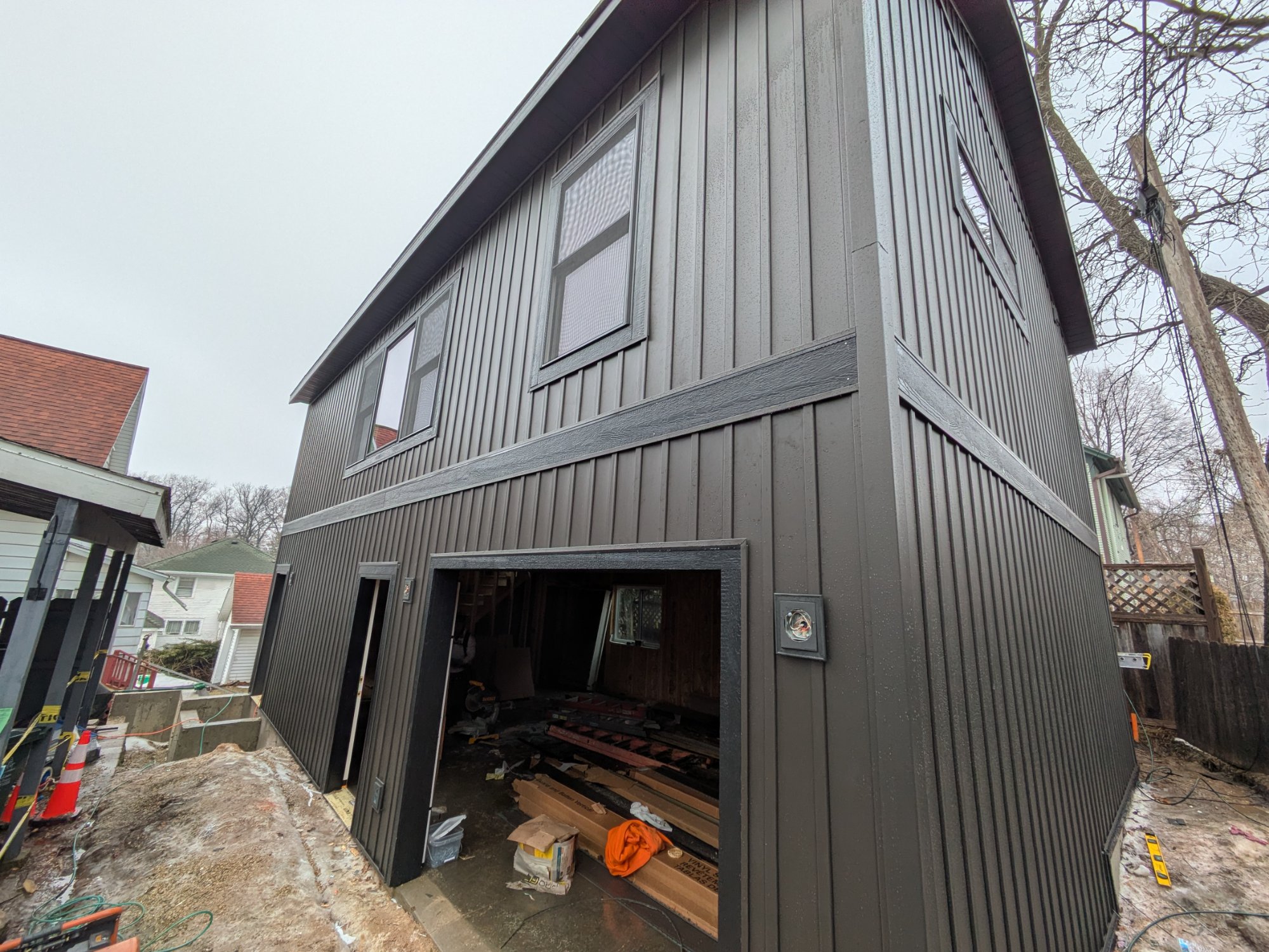 Side view of finished two-story garage ADU — board and batten siding, Madison WI