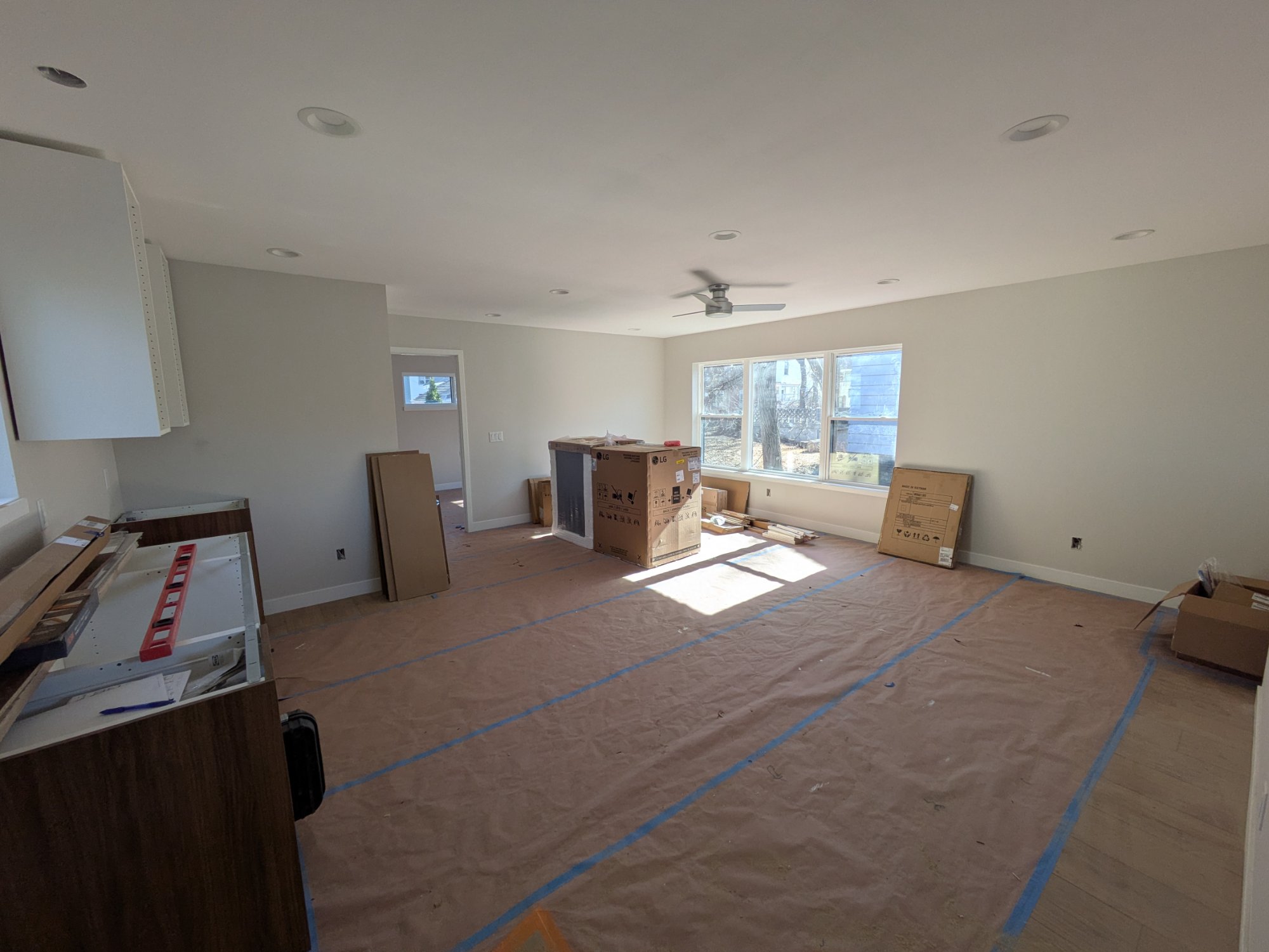 ADU interior at finishing stage with appliances being installed — Madison WI garage ADU