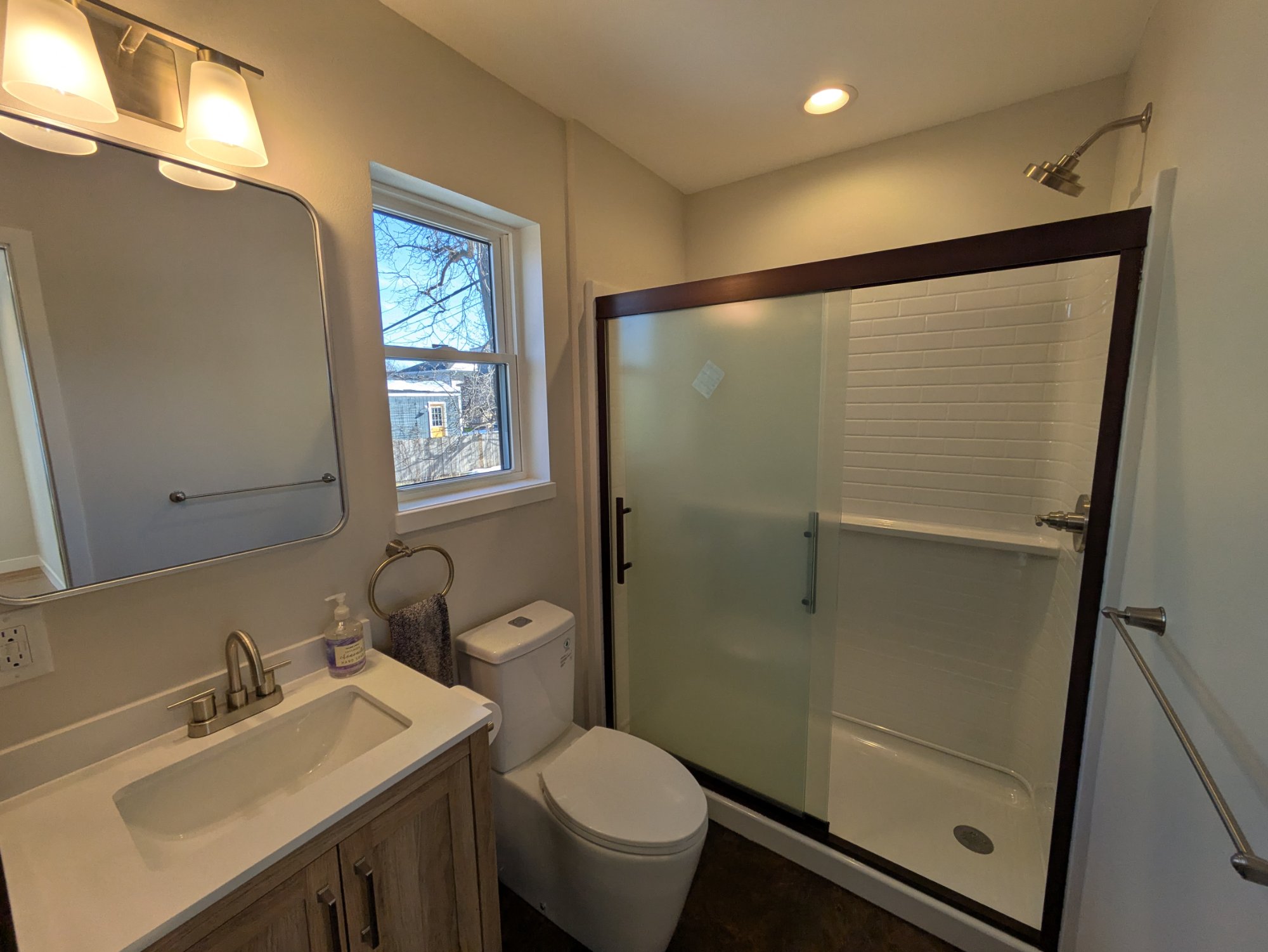 Finished ADU kitchen with stainless appliances and dark countertops — Henry Vilas project Madison WI