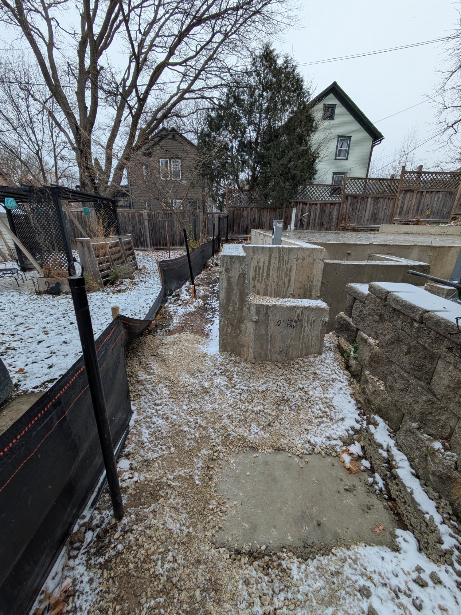 Lumber and materials staged on slab — Henry Vilas ADU framing prep, Madison WI