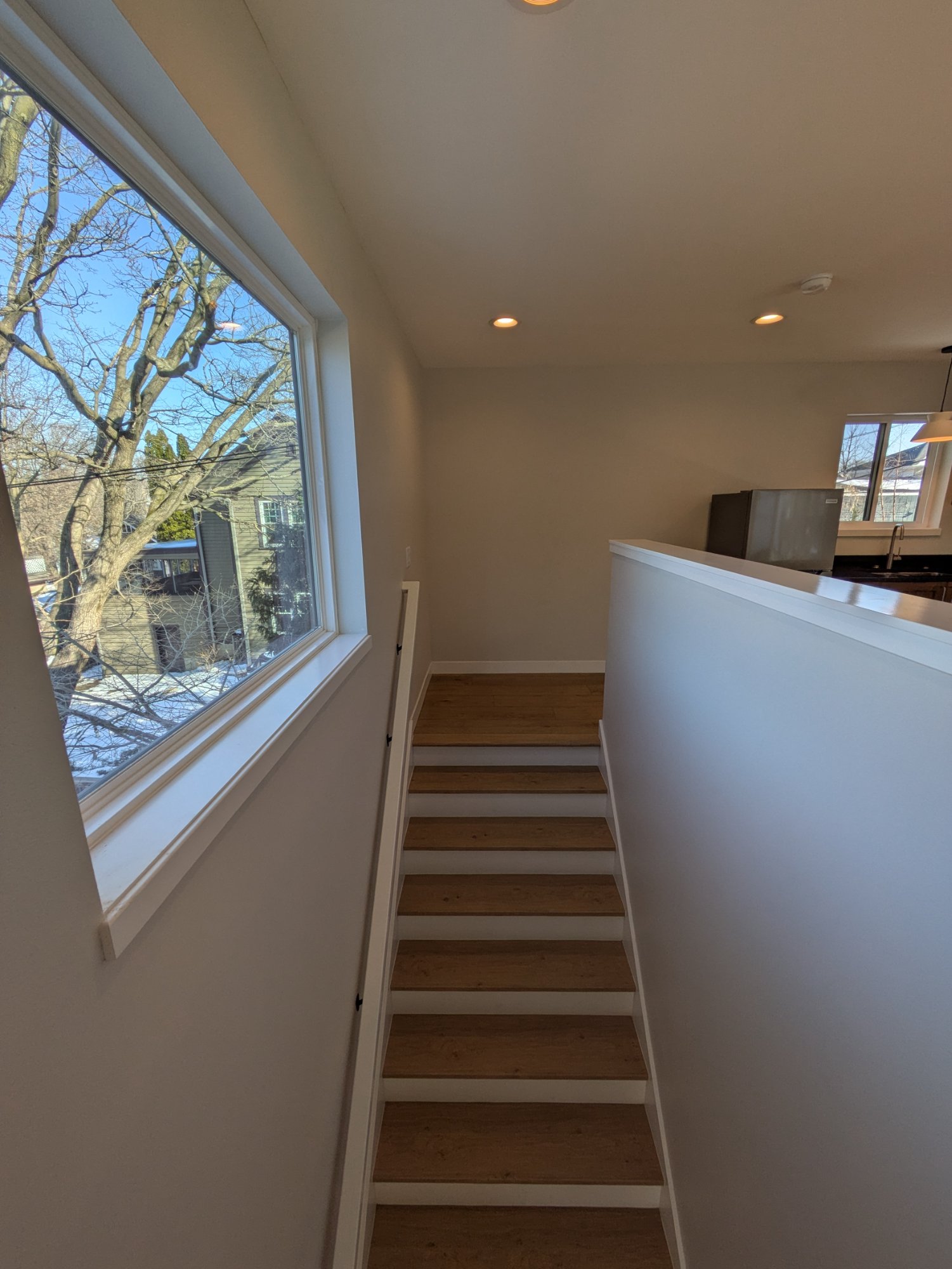 Finished ADU staircase with large picture window — light-filled interior, Madison WI