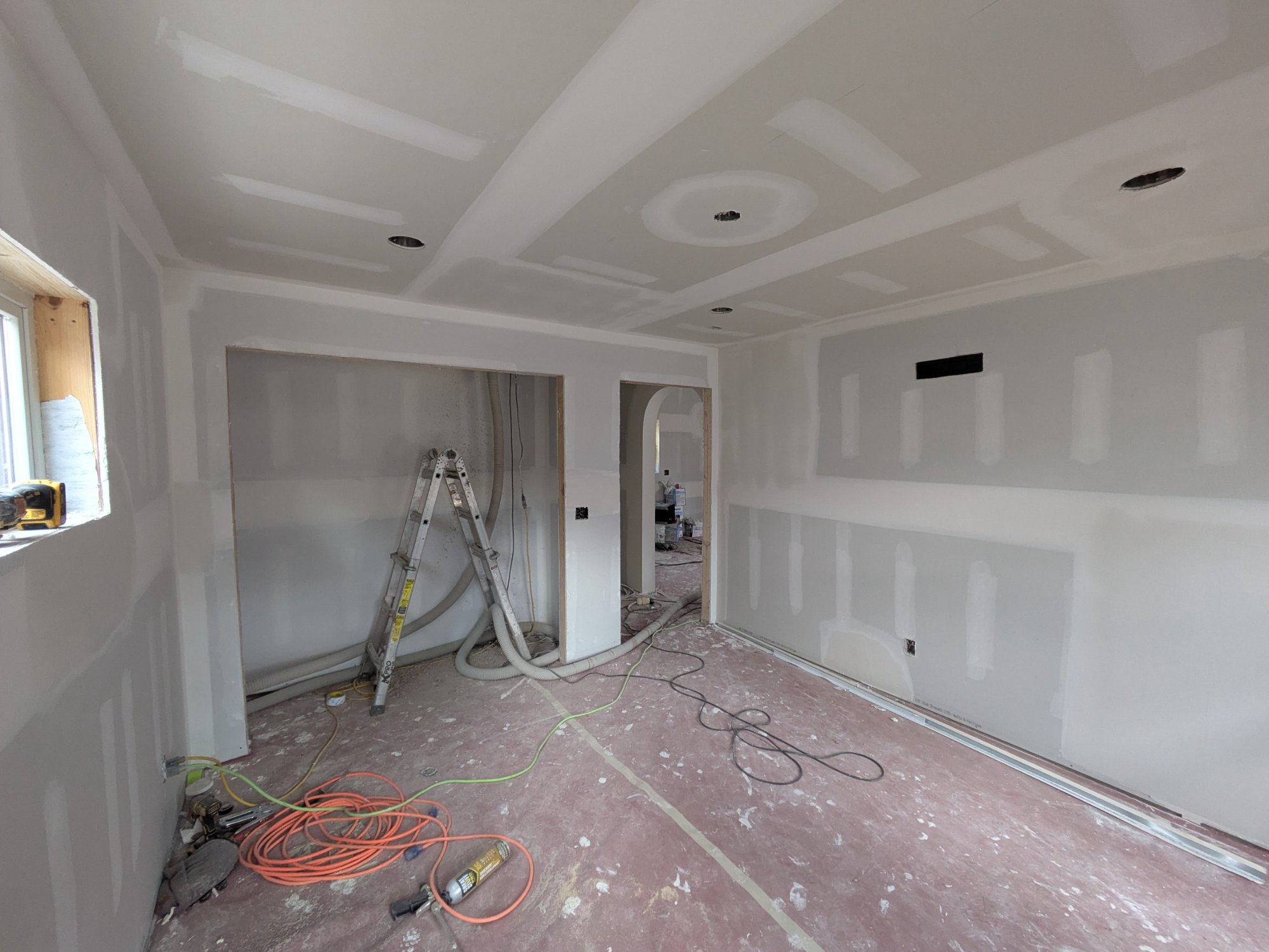 Drywall living area wide view showing hallway and archway detail — North Side ADU Madison WI