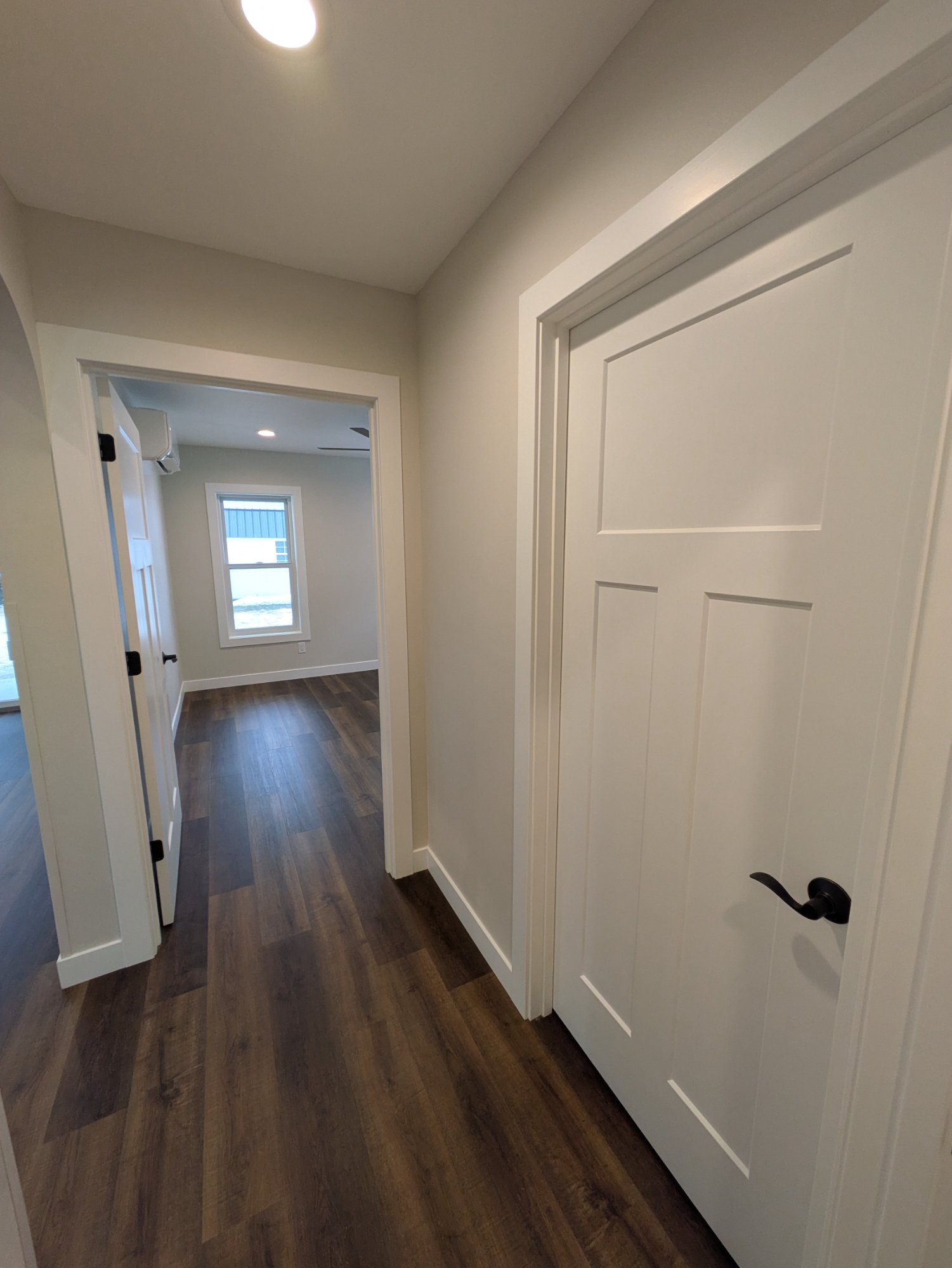 Hallway with craftsman doors and archway back to living area — North Side ADU Madison WI